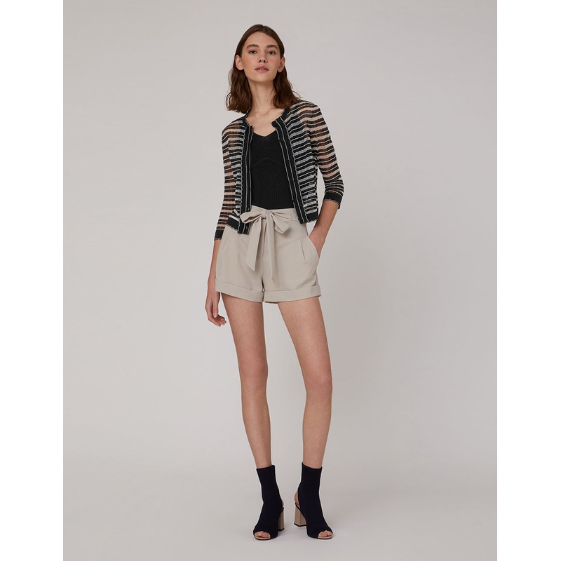 Classic small cardigan has contrasting wavy edges